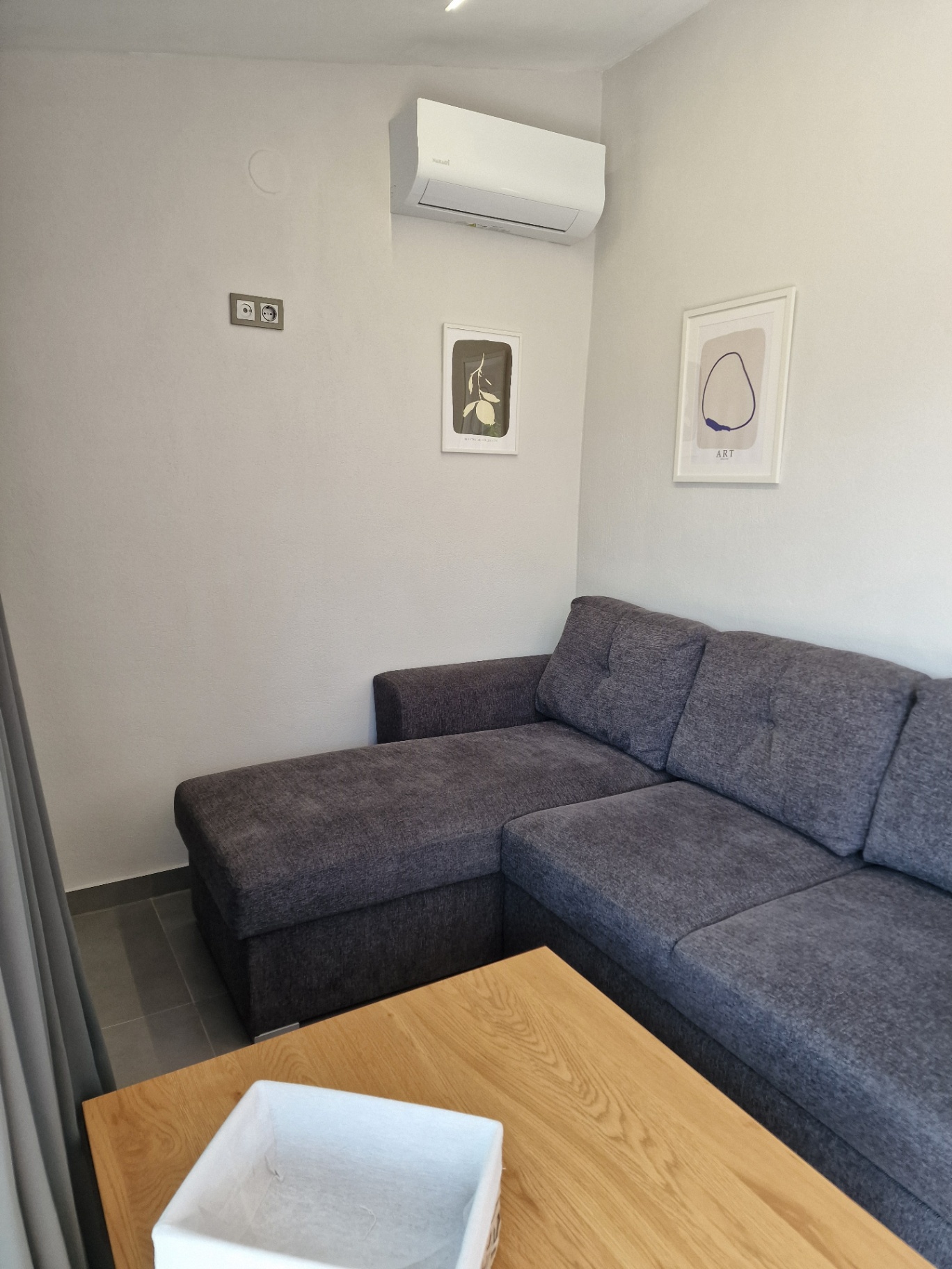 Corner sofa bed and oak table in the living area