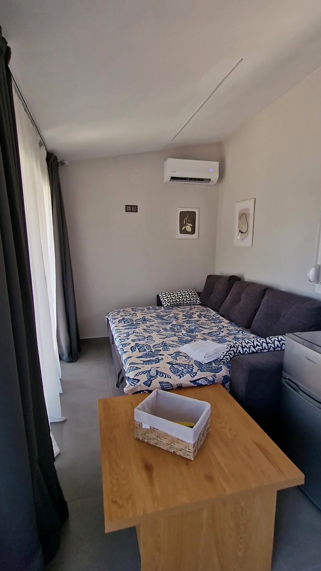 Sofa bed opened out beside the low timber table