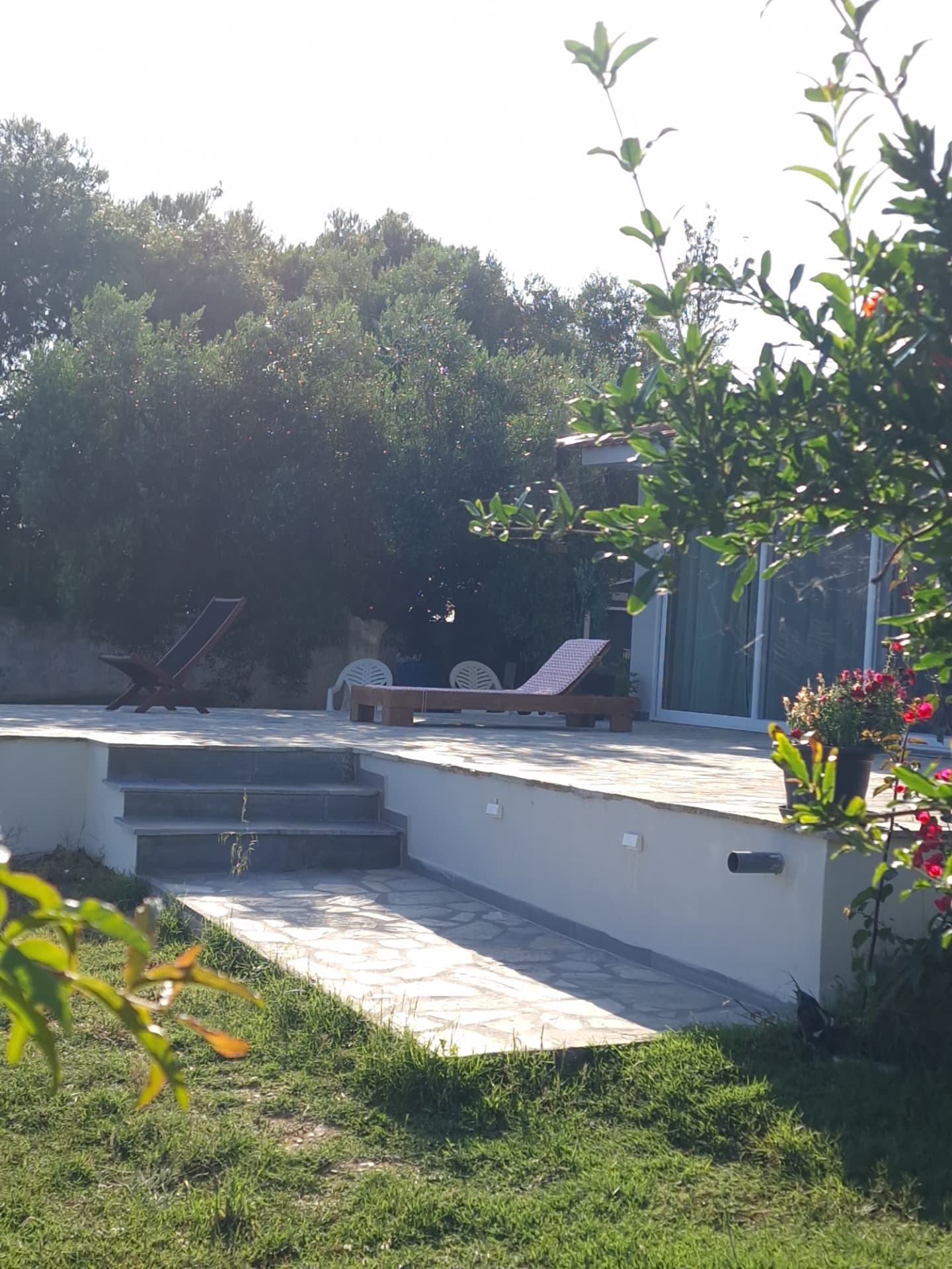 Stone steps leading down to the sun loungers above the sea