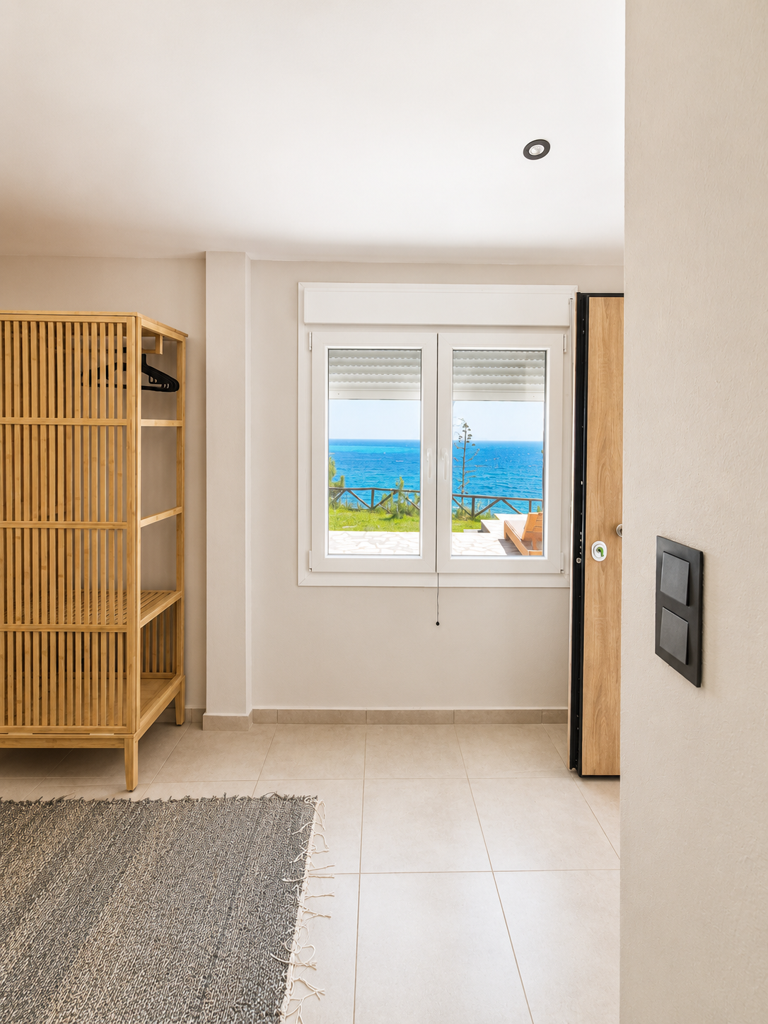 Bedroom window looking out to the Aegean Sea and terrace