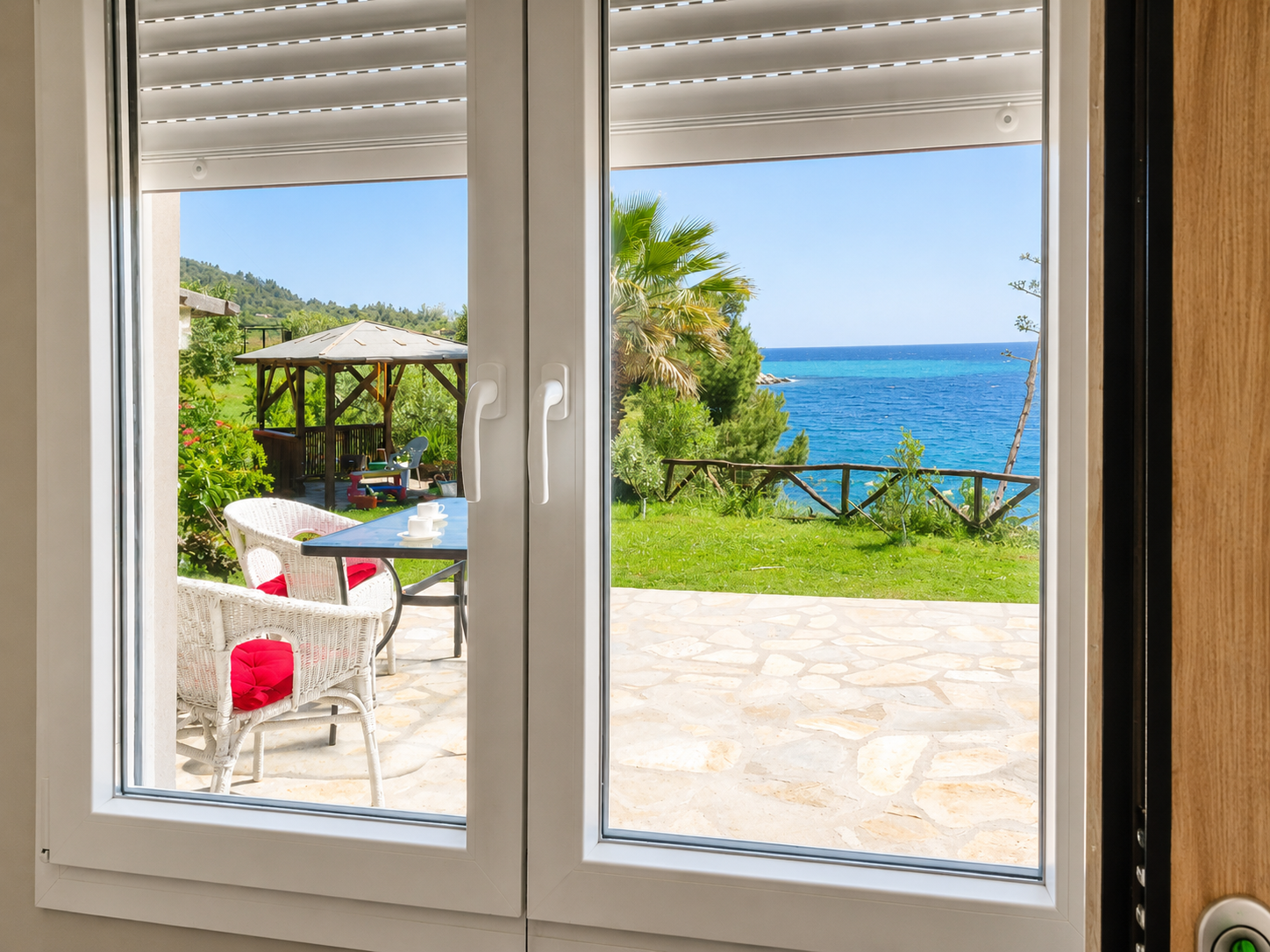 Window framing the gazebo garden and sea